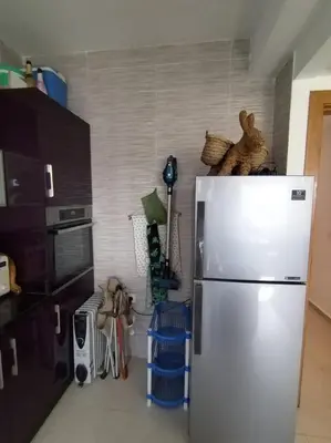 a kitchen with a stainless steel refrigerator in a room at Sunny apartment in El Harhoura
