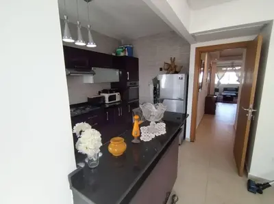 a kitchen with a black counter top with flowers on it at Sunny apartment in El Harhoura