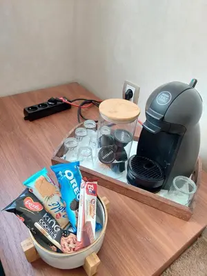 a table with a tray of food and a coffee maker at Charming Flat with Pool view Fast Wi-Fi in Bouznika