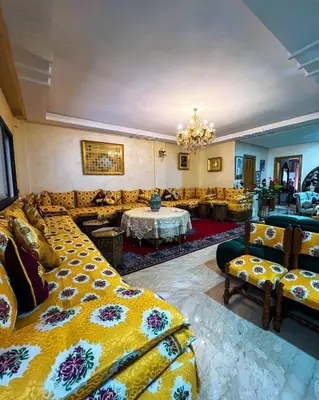 a living room with a bed and a couch at Élégance et Sérénité au Cœur de Casablanca in Casablanca