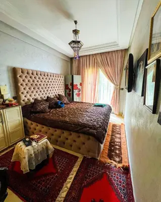 a bedroom with a large bed and a table at Élégance et Sérénité au Cœur de Casablanca in Casablanca