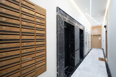 a hallway with wooden lockers in a room at Nice & Comfortable 2BHK panoramic balcony with swimming pool in Aïn Harrouda