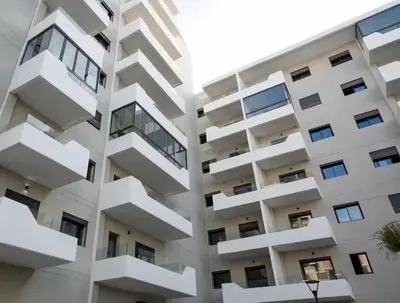 a tall white apartment building with balconies at Nice & Comfortable 2BHK panoramic balcony with swimming pool in Aïn Harrouda