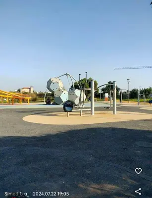 a playground in a park with a roller coaster at Nice & Comfortable 2BHK panoramic balcony with swimming pool in Aïn Harrouda