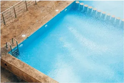 a swimming pool with blue water in it at Nice & Comfortable 2BHK panoramic balcony with swimming pool in Aïn Harrouda