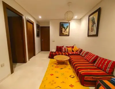 a living room with a couch and a table at Joli appartement au centre-ville de Rabat in Rabat