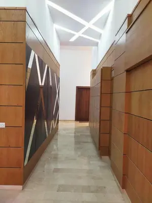 a hallway in a building with wooden panels on the wall at Joli appartement au centre-ville de Rabat in Rabat