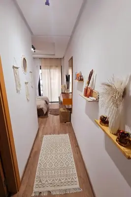 a hallway with a room with a bed and a white rug at Appartement de Luxe - Gare Rabat Agdal in Rabat
