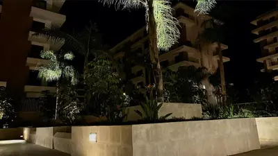 a night view of a building with lights at Appartement de Luxe - Gare Rabat Agdal in Rabat