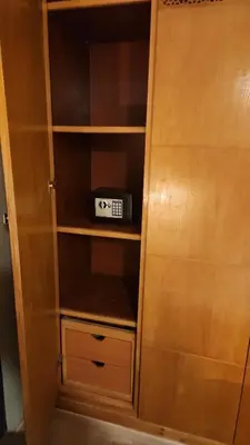 a wooden cabinet with a clock inside of it at Joumaira appartement Beach in Rabat