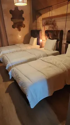a group of three beds in a room at Joumaira appartement Beach in Rabat
