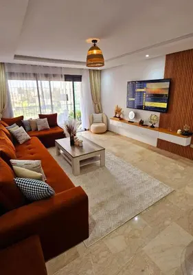 a living room with a couch and a table at Cosy Appartement Rabat Agdal in Rabat