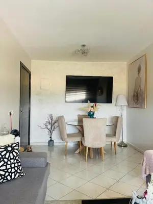 a living room with a table and chairs at Jannat tamaris in Tamaris