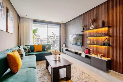 a living room with a green couch and a table at Urban Chic Suite Casablanca city centre - Parking Gym in Casablanca