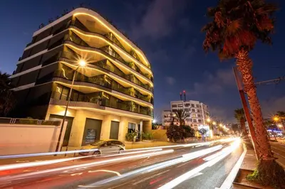 a tall building on a city street at night at Urban Chic Suite Casablanca city centre - Parking Gym in Casablanca