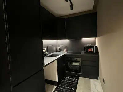 a black kitchen with a sink and a microwave at Urban Chic Suite Casablanca city centre - Parking Gym in Casablanca