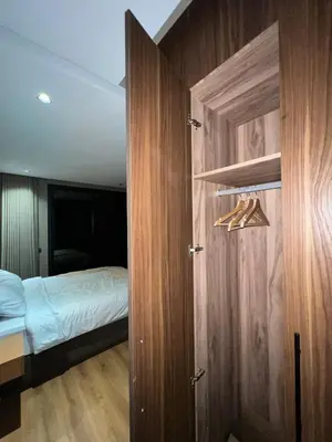 a bedroom with a bed and a door with a closet at Urban Chic Suite Casablanca city centre - Parking Gym in Casablanca