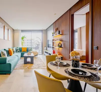 a living room with a couch and a table and chairs at Urban Chic Suite Casablanca city centre - Parking Gym in Casablanca