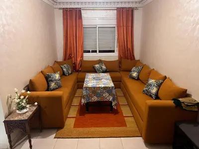 a living room with a couch and a table at Appartement de luxe in Casablanca