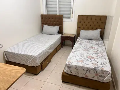 a bedroom with two beds and a window at Appartement de luxe in Casablanca