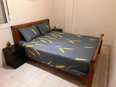 a bed with a blue comforter with gold fish on it at Appartement de luxe in Casablanca