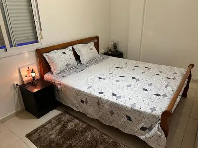 a bedroom with a bed with a quilt on it at Appartement de luxe in Casablanca