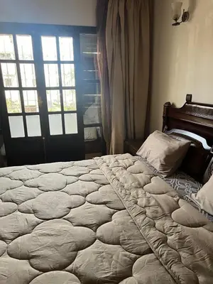 a large bed in a bedroom with a window at Spacious and stylish apartment near stadium Moulay Abdellah in Rabat