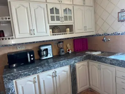 a kitchen counter with white cabinets and a microwave at Spacious and stylish apartment near stadium Moulay Abdellah in Rabat