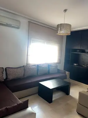 a living room with a couch and a coffee table at Spacious and stylish apartment near stadium Moulay Abdellah in Rabat