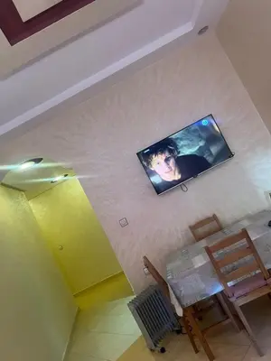 a flat screen tv hanging on a wall at Appartement a settat in Settat