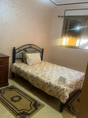 a bedroom with a bed with a laptop on it at Appartement a settat in Settat