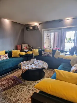 a living room with blue couches and a table at Les perles de tamaris in Casablanca