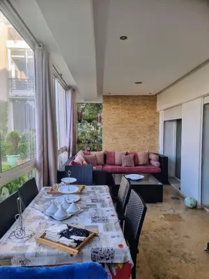 a living room with a table and a couch at Les perles de tamaris in Casablanca