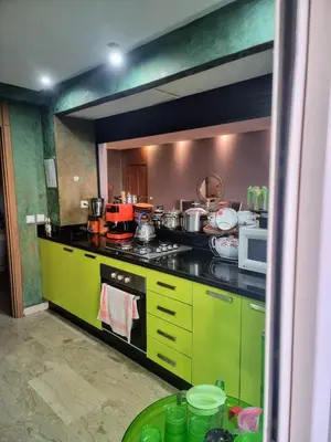 a kitchen with yellow and black counters and appliances at Les perles de tamaris in Casablanca