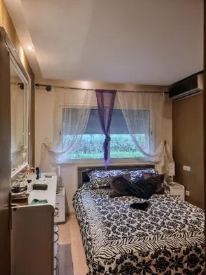 a small bedroom with a bed and a window at Les perles de tamaris in Casablanca