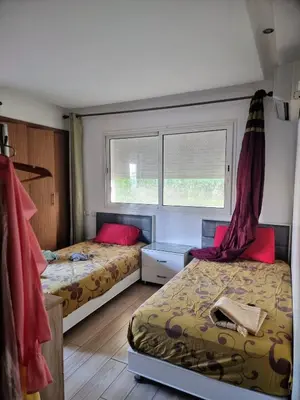 a bedroom with two beds and a window at Les perles de tamaris in Casablanca