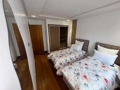 a bedroom with two beds and a window at RÉSIDENCE LE BIjOU DE L'AGDAL in Rabat