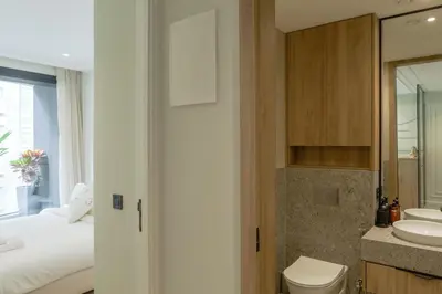 a bathroom with a bed and a sink and a toilet at Résidence Claridge Racine in Casablanca