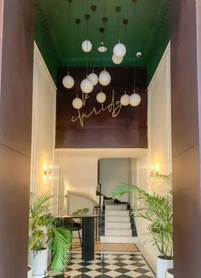 a staircase with a green ceiling and a chandelier at Résidence Claridge Racine in Casablanca