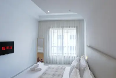 a white room with a bed with a window at Résidence Eden - Maarif in Casablanca