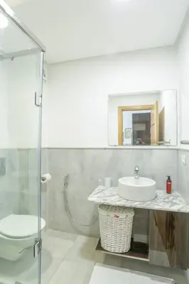 a bathroom with a sink and a toilet and a mirror at Résidence Eden - Maarif in Casablanca