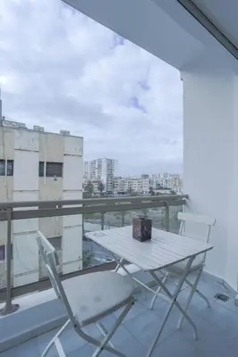 a white table and two chairs on a balcony at Résidence Eden - Maarif in Casablanca