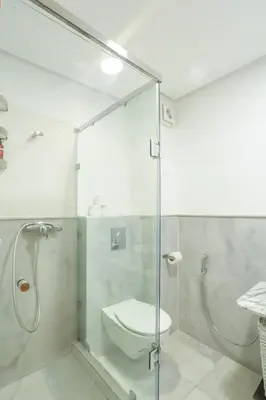 a bathroom with a glass shower stall with a toilet at Résidence Eden - Maarif in Casablanca