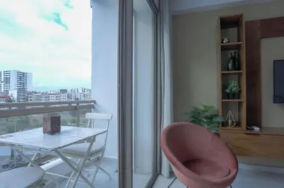 a table and a chair in a room with a window at Résidence Eden - Maarif in Casablanca