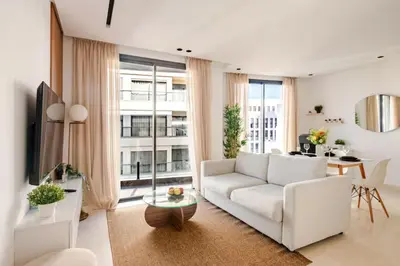 a living room with a white couch and a large window at Appartement de luxe - Les Princesses avec Parking in Casablanca