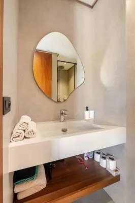 a bathroom with a sink and a mirror at Appartement de luxe - Les Princesses avec Parking in Casablanca