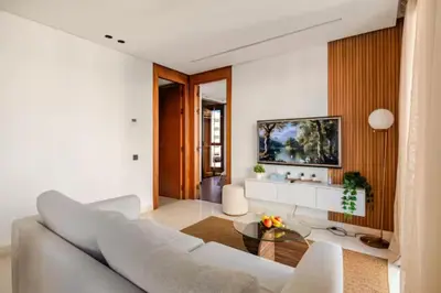 a living room with a couch and a table at Appartement de luxe - Les Princesses avec Parking in Casablanca