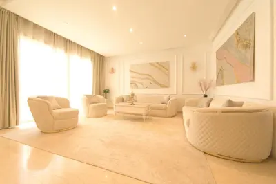 a living room with white furniture and a large window at 165m luxury Family apartment in prestigia rabat in Rabat
