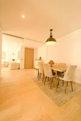 a dining room with a wooden table and chairs at 165m luxury Family apartment in prestigia rabat in Rabat