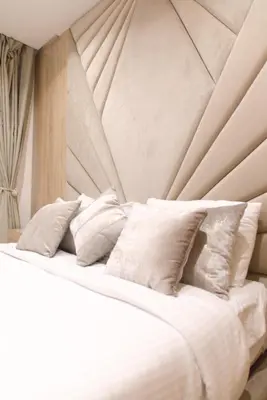 a white bed with white pillows on it at 165m luxury Family apartment in prestigia rabat in Rabat